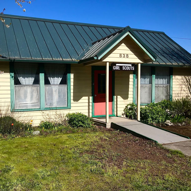 Headline reads, "Port Townsend Girl Scout House - Est. 1942" below an illustrated lighthouse set against a yellow background.