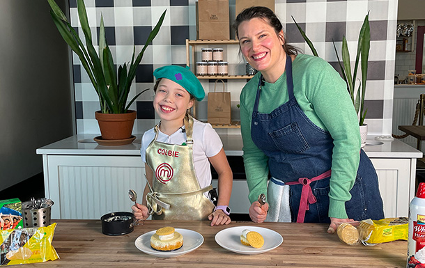 Girl Scout Colbie and Hot Cakes Head Pastry Chef Brittany Bardelben in a kitchen with Colbie's Lemon-Ups Cheesecake Cups.