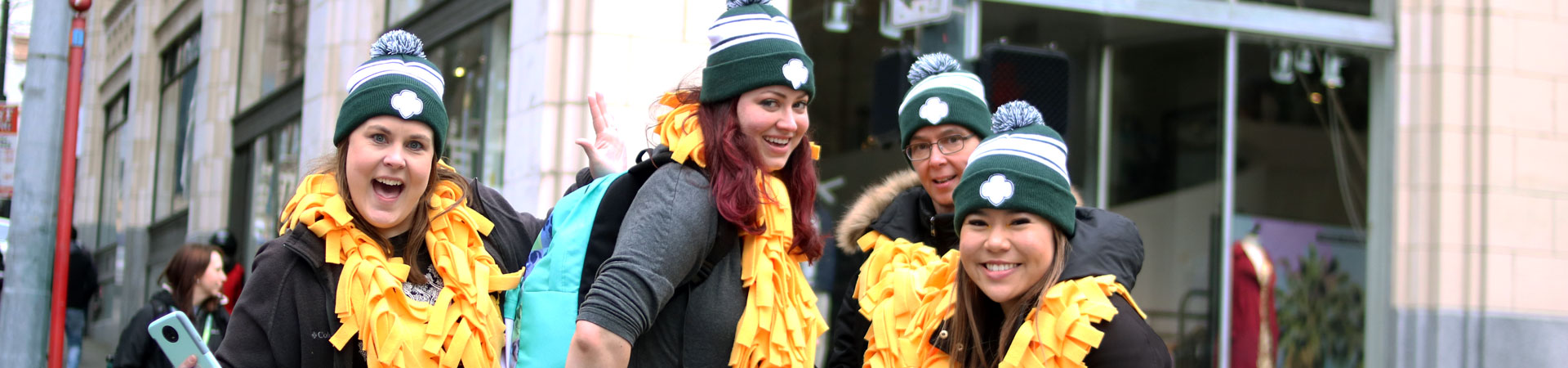  Girl Scout staff dressed in Girl Scout gear for a parade. 