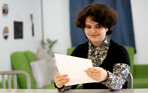 A volunteer sitting at a table viewing documents.