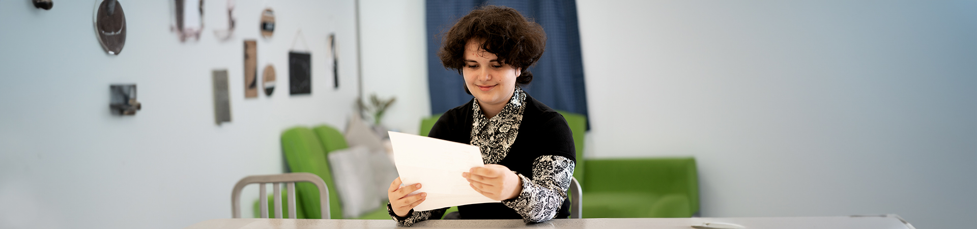  A volunteer sitting at a table reviewing documents. 